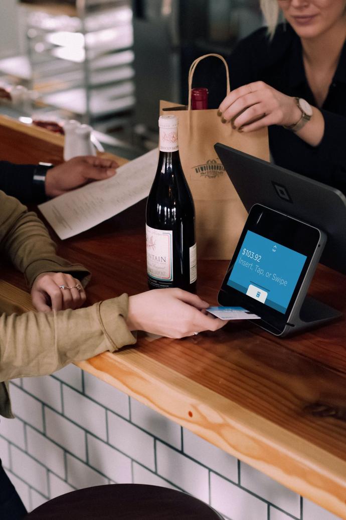 person playing card on POS machine